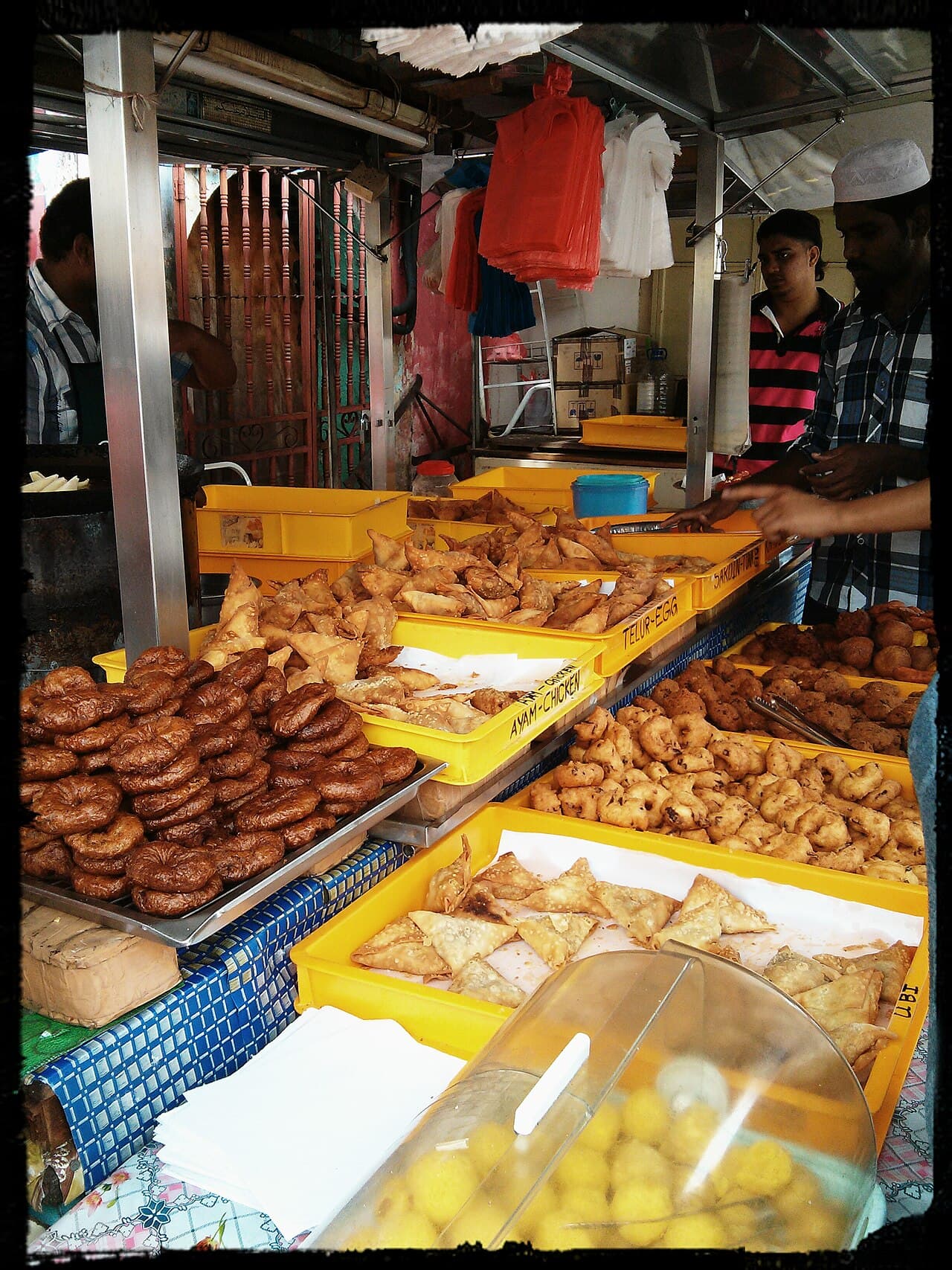 Trays of fried Indian snacks and sweets at a Little India stall in Penang